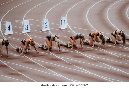 race female athletes runners start at 100 meters - Powered by Shutterstock