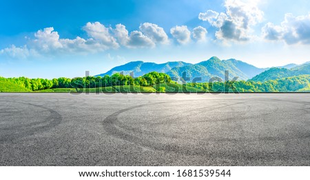 Race track road and green tea mountain on a sunny day,panoramic view.