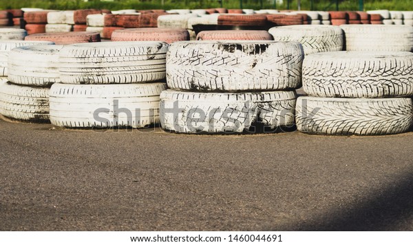 Race\
track safety barrier. asphalt racing track with red and white\
tires. colorful tires stack. karting race\
track