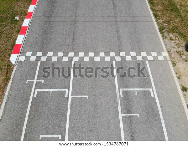 Race track with starting or end line, aerial\
view background