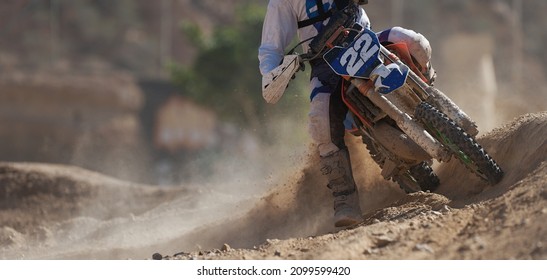 Racer Boy On Motorcycle Participates In Motocross Race, Active Extreme Sport, Flying Debris From A Motocross In Dirt Track