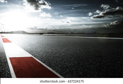 Racetrack with red and white safety sideline ,dramatic cloudy sky and cold mood filter apply .