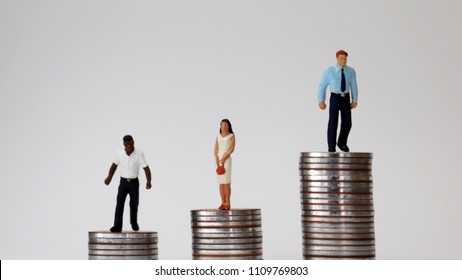 Racial And Economic Inequality Concepts. Miniature people standing on pile of coins.