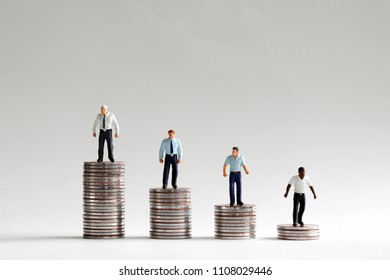 Racial Pay Gap Concepts. Pile Of Coins And Miniature People.