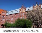 Raciborz city in Poland. Raciborz landmark - Jagiello square (Polish: Plac Jagielly) with old social welfare home. Spring cherry blossoms.