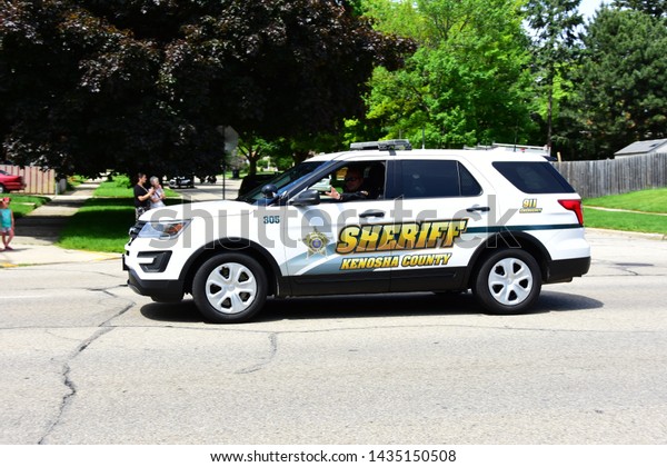 Racine,\
Wisconsin / USA - June 26, 2019: Kenosha Police from neighboring\
county  participate in the funeral procession for John Hetland\
killed during an armed robbery while off duty.\
