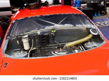 Racing Car Gas Tank. Sports Car Engine With Turbine. An Open Race Car Hood On A Pit Stop While Racing On A Race Track. Motor With Turbocharger. Boos And Tunning.