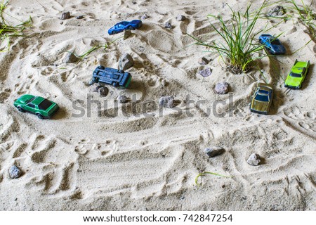 Racing cars on the sand compete in the game. Machines are trying to outrun each other.