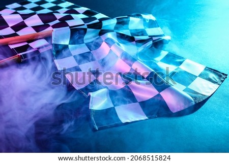 Racing flags and smoke on dark background