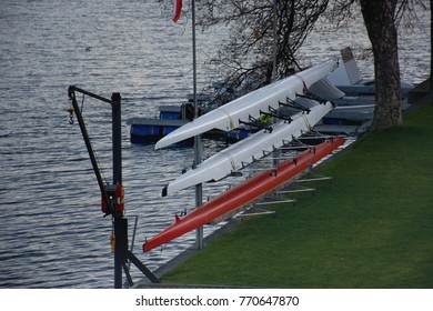 Racing rowing boats placed on the shore and prepared for the next race - Powered by Shutterstock