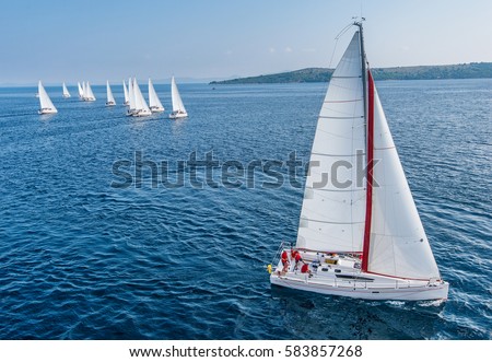 Racing sail boat from bird view, many of sailing boats in background
