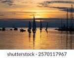 Racing sailboats and yachts at the seafront of Thessaloniki, Greece at sunset