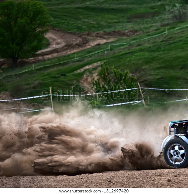 racing\
sports car in dust clubs on the track , rally\
