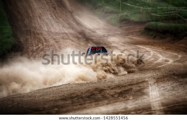 Racing\
sports car in dust clubs on the track ,\
rally