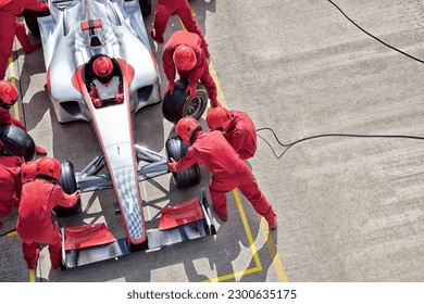Racing team working at pit stop - Shutterstock ID 2300635175