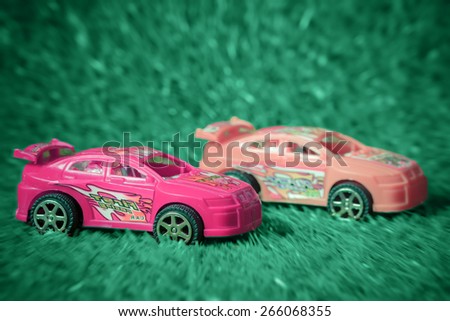 Racing toy car on pastel style grass made with effect radial zoom