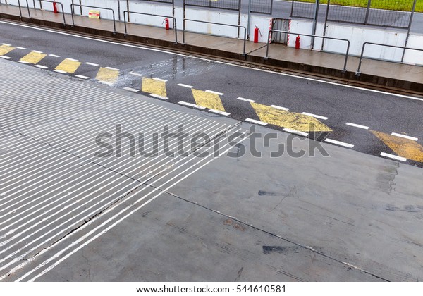 Racing track pit\
lane asphalt in the rainy\
day