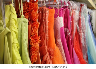 Rack of brightly coloured prom dresses