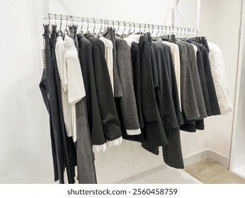 A rack of clothes hanging on a rail in a closet. - Powered by Shutterstock