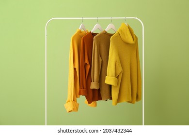 Rack with clothes on color background - Powered by Shutterstock