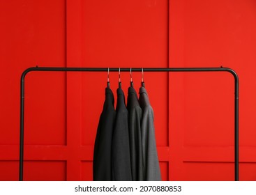 Rack With Clothes On Color Background