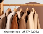 Rack with coats near color wall in dressing room