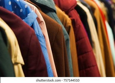 Rack With Colourful Coats. Charity Second Hand Clothes.