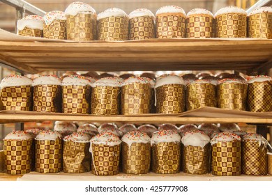 rack with easter cakes at the industrial bakery background texture 