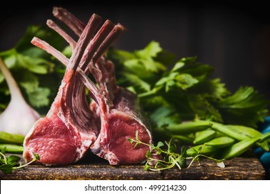Rack of lamb , raw meat with bone on rustic kitchen table at wooden background, side view
