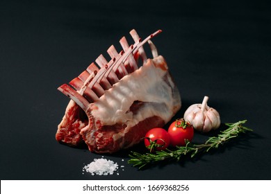 A rack of new Zealand Lamb in raw form on a black background