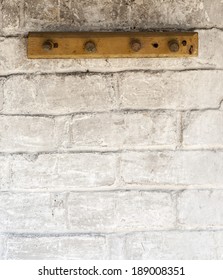 rack on the weathered white brick wall