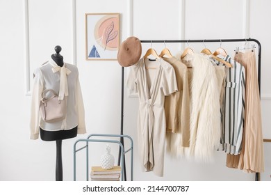 Rack With Stylish Clothes In Modern Studio Of Fashion Stylist