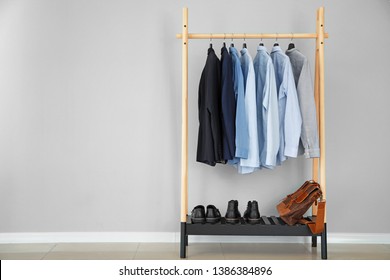 Rack With Stylish Male Clothes Near Light Wall