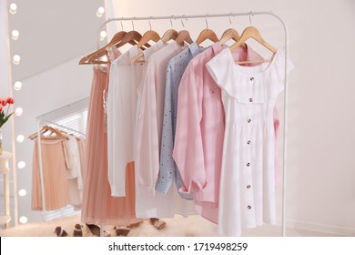 Rack with stylish women's clothes and mirror indoors. Interior design - Shutterstock ID 1719498259