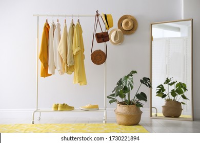 Rack with stylish women's clothes and mirror indoors. Interior design - Shutterstock ID 1730221894