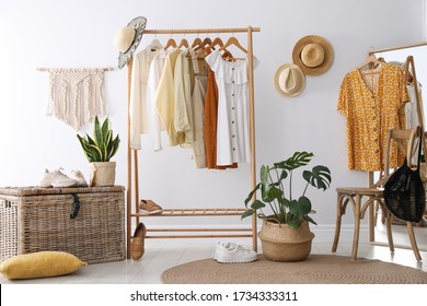 Rack with stylish women's clothes and mirror indoors. Interior design - Powered by Shutterstock