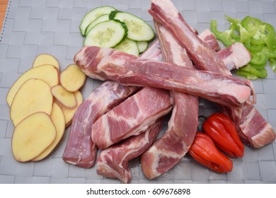 Rack Of Uncooked Ribs With Chili Peppers And Vegtables