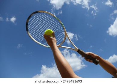 Racket and ball for big tennis, on the background of the sky. - Powered by Shutterstock