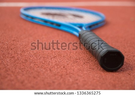 Racket on the tennis hardcourt