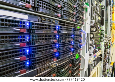 Racks with computer server devices. Hosted services are in the datacenter room. Cloud storage technologies.  Information center for data storage and processing.