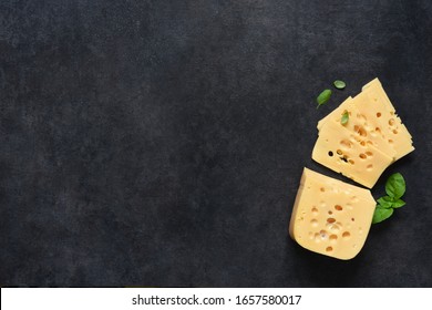 Radamer cheese on a black concrete background. View from above.