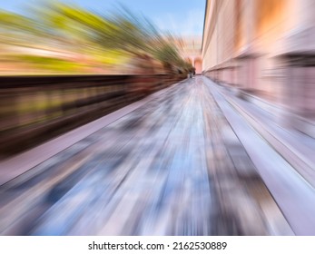 Radial Blur Of Exterior Walkway With Polished Marble Tiles Between Balustrade (left) And Columns (right) Above Courtyard Of Urban Art Museum, For Concepts Of Time And Perception