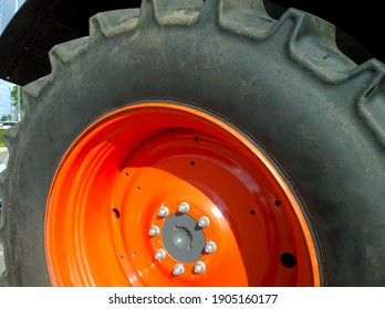 Radial Tyre And Orange Color Disk Of New Modern Tractor Wheel. Higher Load Capacity. Agricultural Machinery. Farmer Business. Manufacturing Equipment. Best Technology. Tire.