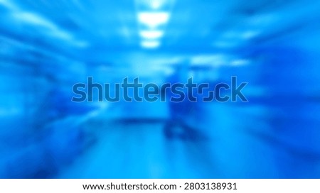 A radial zoom blur effect creates a sense of speed and motion in a bright blue scientific laboratory or cleanroom environment