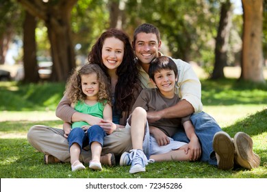 Radiant Family Sitting In The Garden