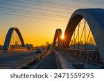 Radiant glow of the setting sun casting golden hues upon the arches of the renowned 6th Street Bridge in Los Angeles, overlooking the city.