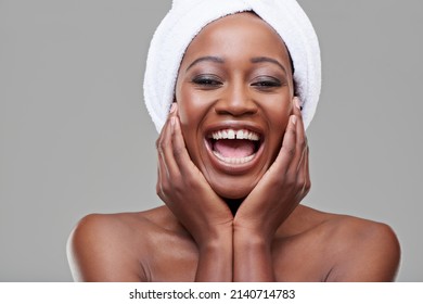 Radiant Laughter. Studio Shot Of A Young Woman With Beautiful Skin Being Cheerful.