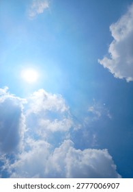 Radiant Sunlight Piercing Through Clouds on a Deep Blue Vertical Sky