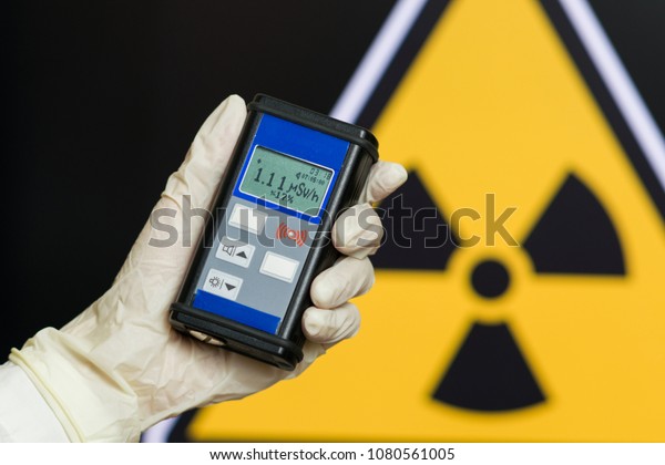 radiation supervisor with\
geiger counter checks the level of radioactive radiation in the\
danger zone