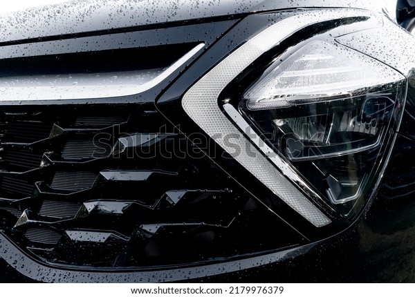 Radiator grille pattern. Car radiator grill close\
up with water drops. Chrome grill of big powerful car engine. Car\
exterior details